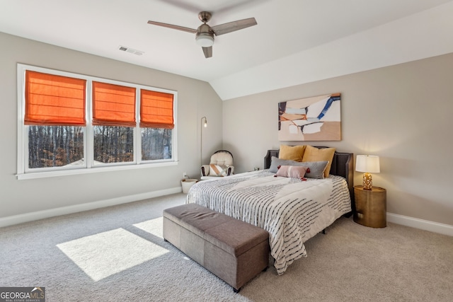 carpeted bedroom with vaulted ceiling, a ceiling fan, visible vents, and baseboards