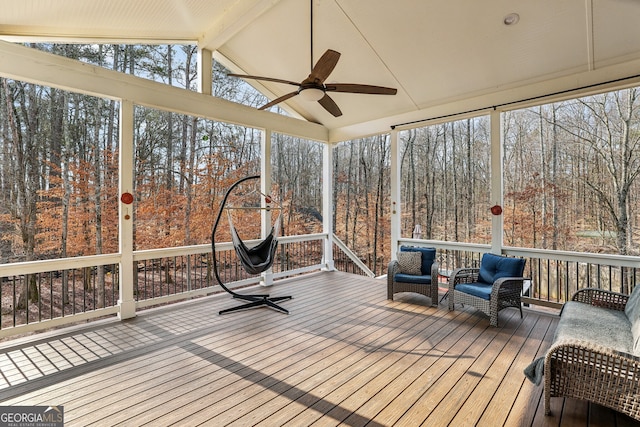 unfurnished sunroom featuring ceiling fan and lofted ceiling with beams