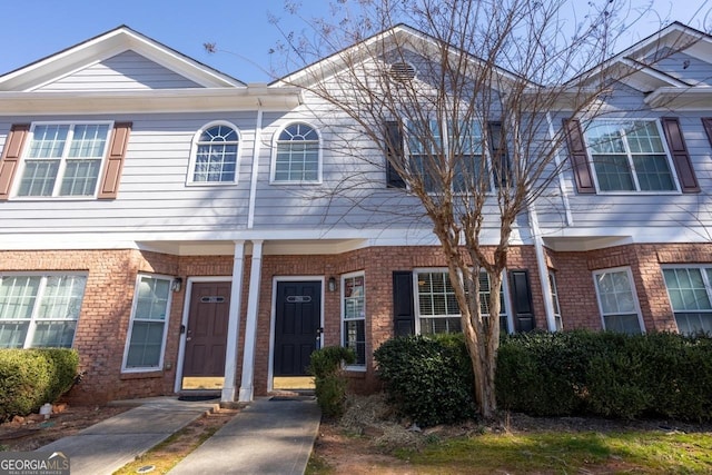 view of property featuring brick siding