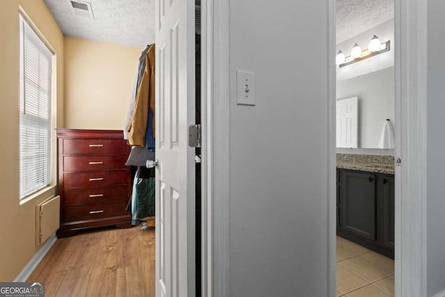 walk in closet featuring visible vents and light wood finished floors