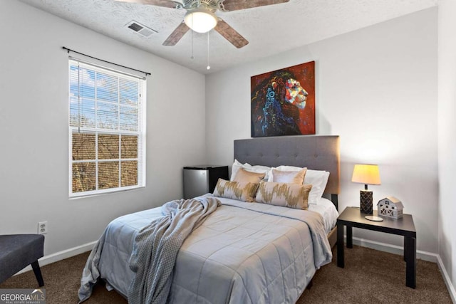 carpeted bedroom featuring visible vents, ceiling fan, a textured ceiling, and baseboards