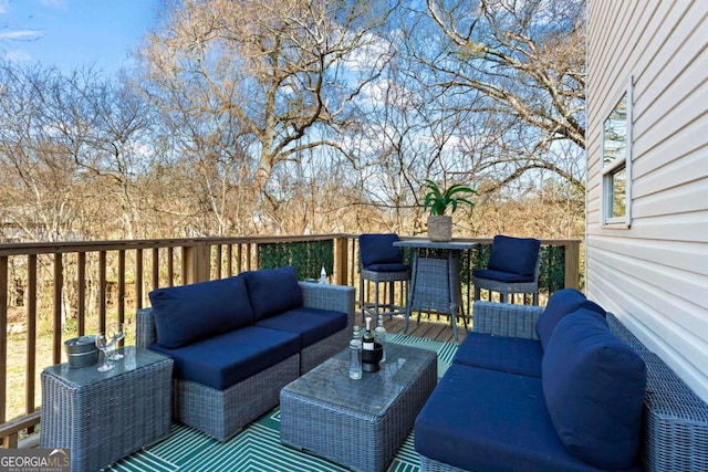 wooden terrace with outdoor lounge area