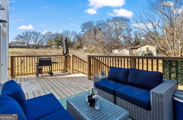 wooden deck featuring a grill and an outdoor living space