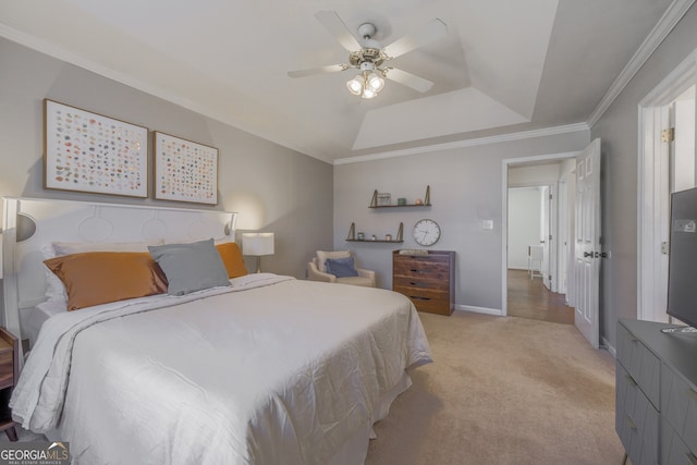 bedroom featuring baseboards, a ceiling fan, light colored carpet, ornamental molding, and a tray ceiling