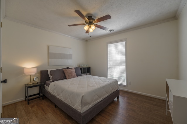 bedroom featuring a textured ceiling, wood-type flooring, visible vents, and crown molding