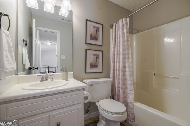 full bathroom featuring shower / tub combo, vanity, and toilet