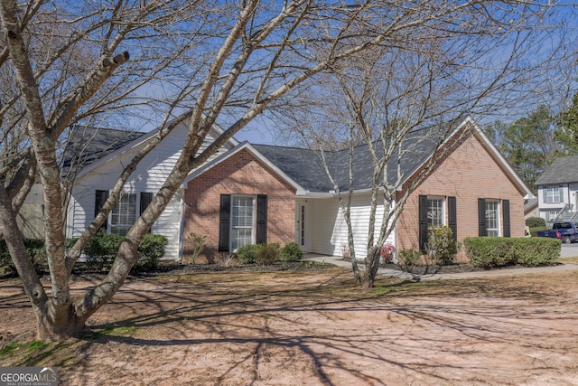 single story home featuring brick siding