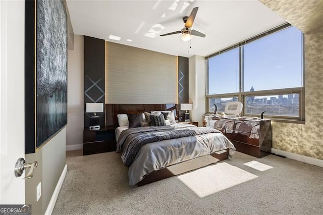 carpeted bedroom featuring a ceiling fan and baseboards