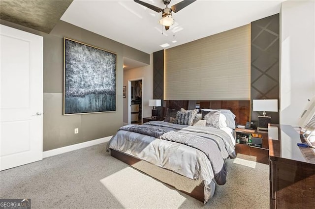 carpeted bedroom featuring baseboards and a ceiling fan