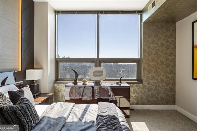 carpeted bedroom with visible vents, baseboards, and wallpapered walls