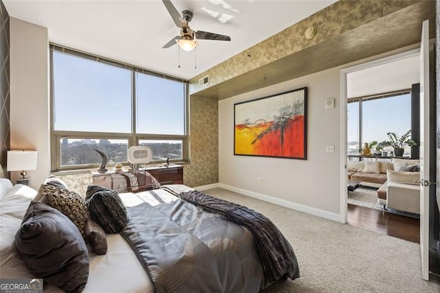 bedroom featuring ceiling fan, carpet floors, visible vents, and baseboards