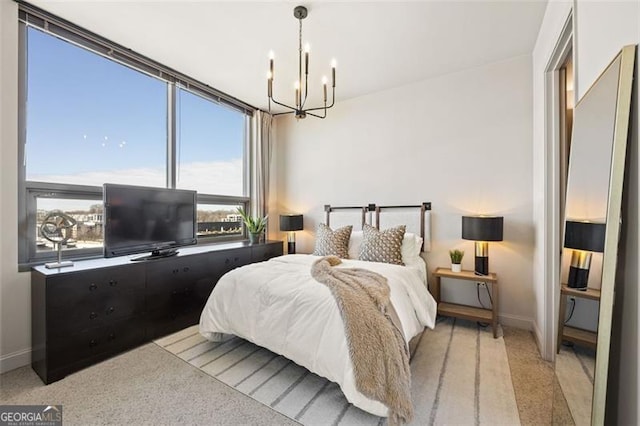 bedroom featuring baseboards and a chandelier