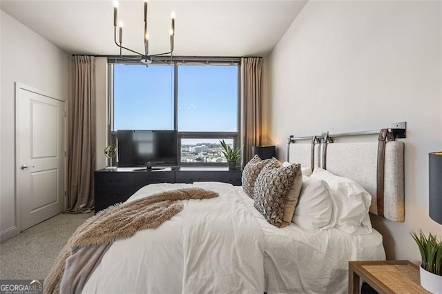 bedroom with carpet floors and a notable chandelier