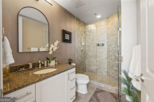 full bathroom featuring toilet, a stall shower, tile patterned flooring, and vanity