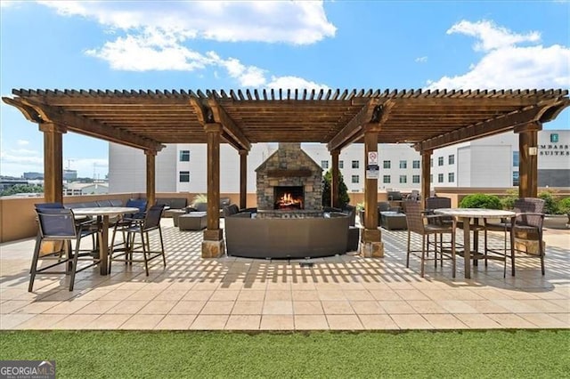 view of patio with outdoor dining space, an outdoor living space with a fireplace, and a pergola