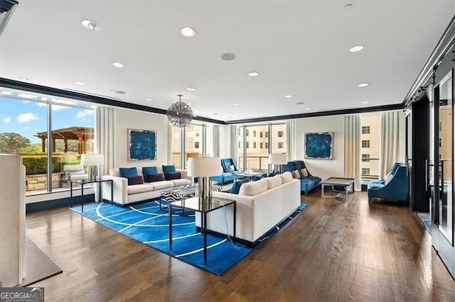 living area with wood finished floors, expansive windows, crown molding, a chandelier, and recessed lighting