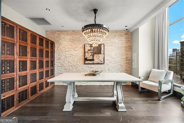 wine cellar with a chandelier, visible vents, and wood finished floors