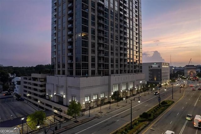 property at dusk featuring a city view