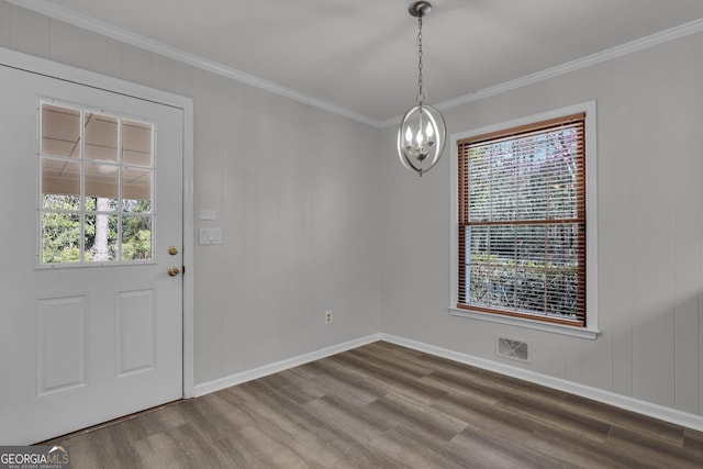 unfurnished dining area with a notable chandelier, plenty of natural light, visible vents, and wood finished floors