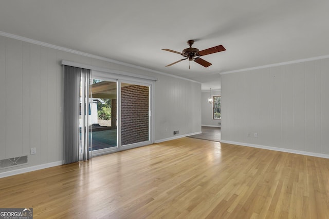 unfurnished room with ceiling fan with notable chandelier, visible vents, light wood-style flooring, and crown molding