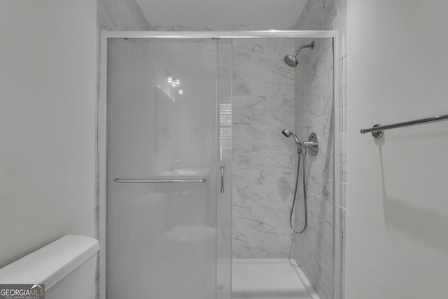 full bath with a shower stall and toilet