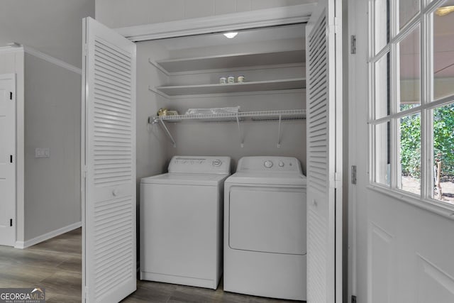 washroom with laundry area, baseboards, washer and clothes dryer, and dark wood-type flooring