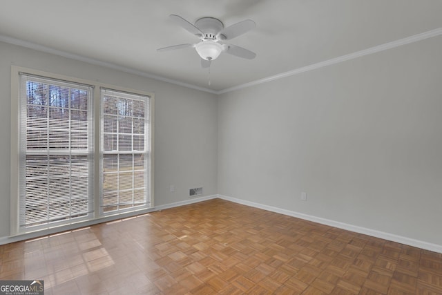 spare room featuring ornamental molding, visible vents, and baseboards