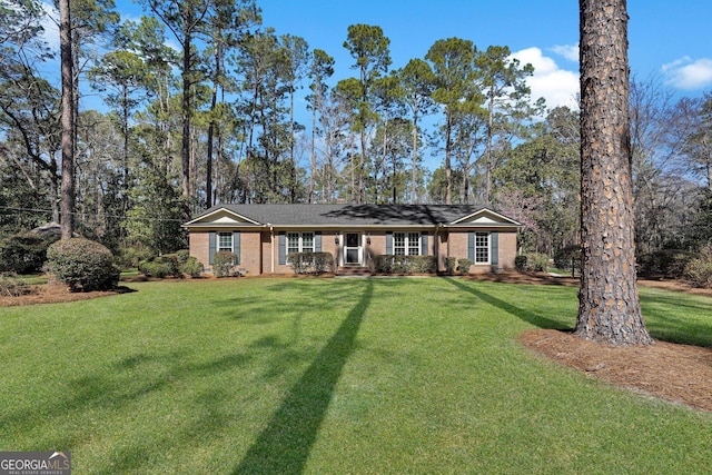 ranch-style home with brick siding and a front yard