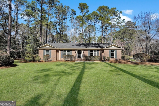 single story home featuring a front lawn and brick siding