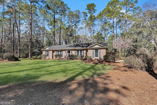 single story home with brick siding and a front lawn