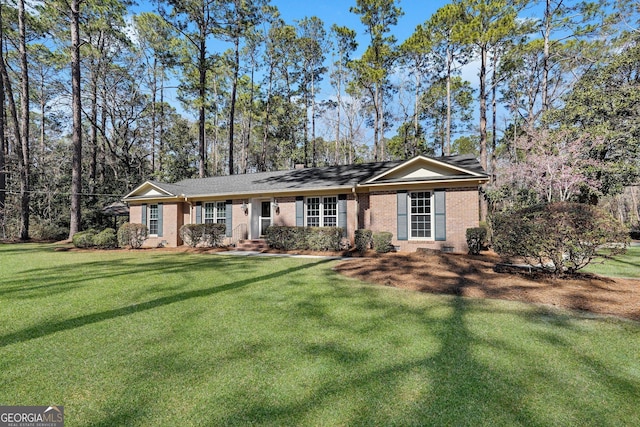 ranch-style house with a front lawn and brick siding