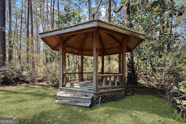 wooden deck with a yard and a gazebo