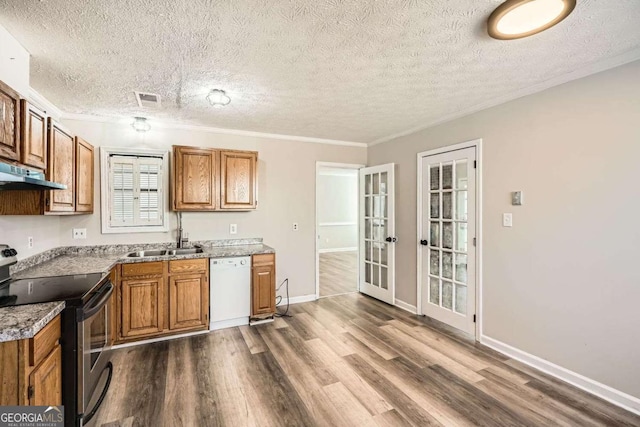 kitchen with stainless steel range with electric stovetop, white dishwasher, visible vents, and brown cabinets