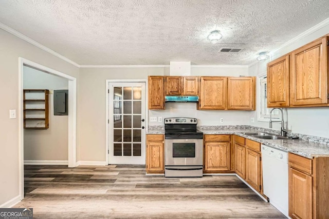 kitchen with visible vents, wood finished floors, white dishwasher, stainless steel range with electric cooktop, and a sink