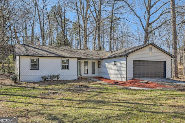 single story home featuring driveway, a front lawn, and an attached garage