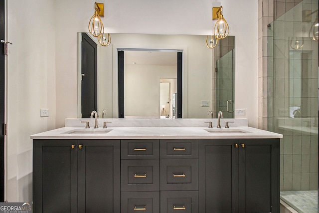 bathroom featuring double vanity, tiled shower, and a sink