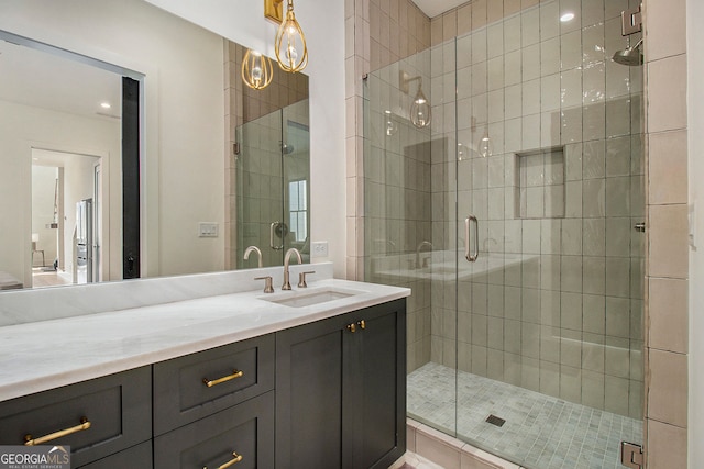 bathroom featuring a shower stall and vanity