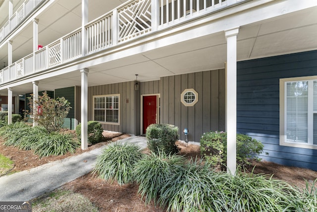 property entrance featuring board and batten siding