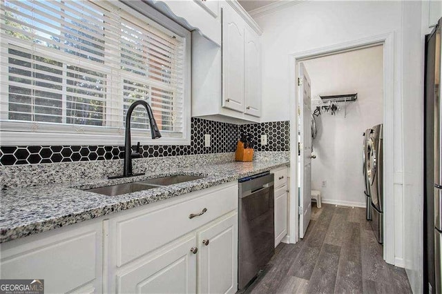 kitchen featuring decorative backsplash, dark wood-type flooring, white cabinetry, a sink, and dishwasher