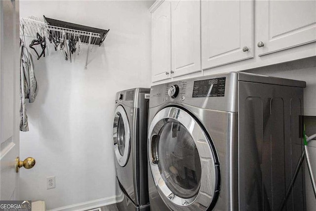 laundry area featuring washing machine and dryer and cabinet space