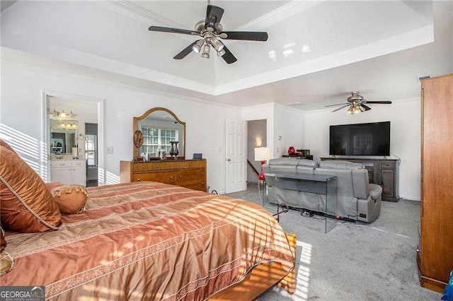 bedroom featuring carpet floors, a raised ceiling, crown molding, and a ceiling fan