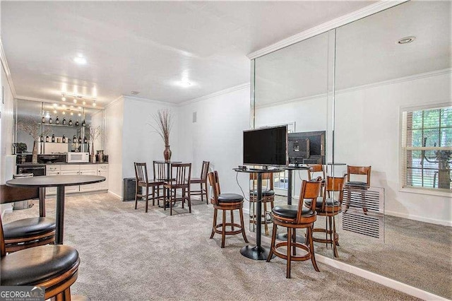 interior space featuring baseboards, a bar, and crown molding