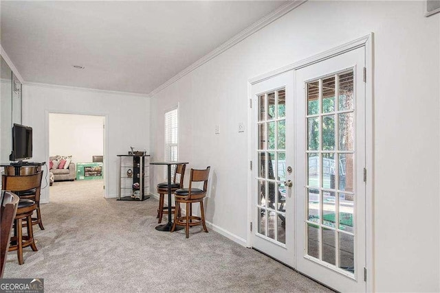 sitting room featuring carpet, ornamental molding, baseboards, and french doors