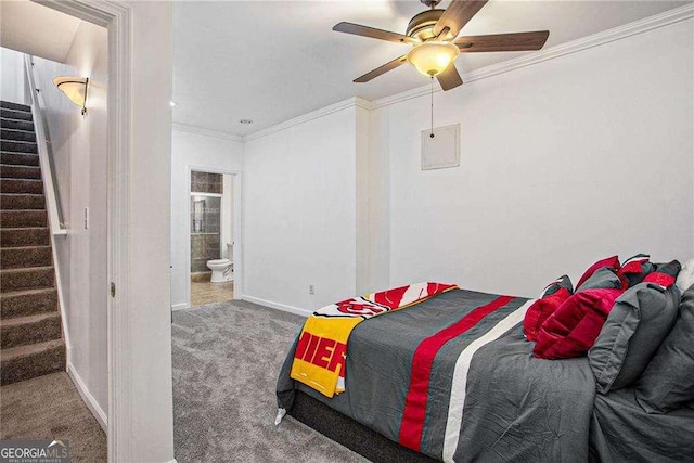 carpeted bedroom featuring a ceiling fan, connected bathroom, baseboards, and crown molding