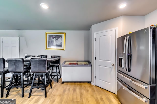 dining area featuring recessed lighting and light wood-style floors