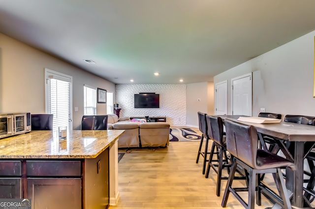 kitchen with visible vents, light wood finished floors, light stone counters, recessed lighting, and a toaster