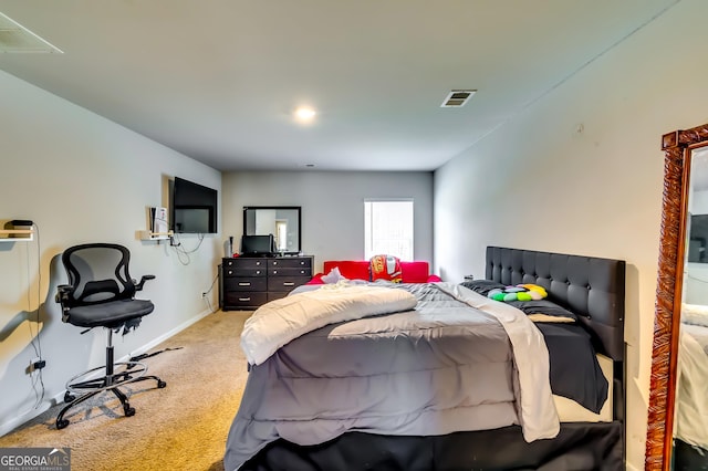 bedroom with visible vents, baseboards, and light colored carpet