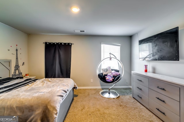 bedroom featuring light carpet, visible vents, and baseboards