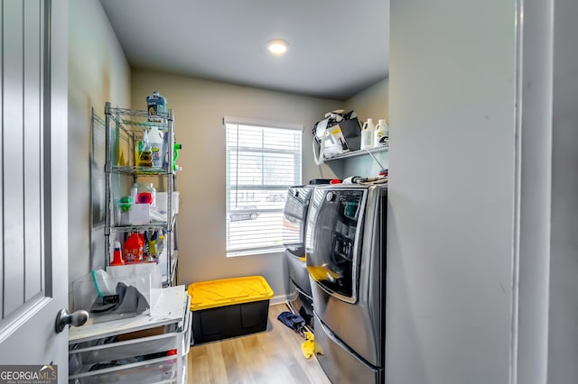 washroom featuring laundry area, independent washer and dryer, and wood finished floors