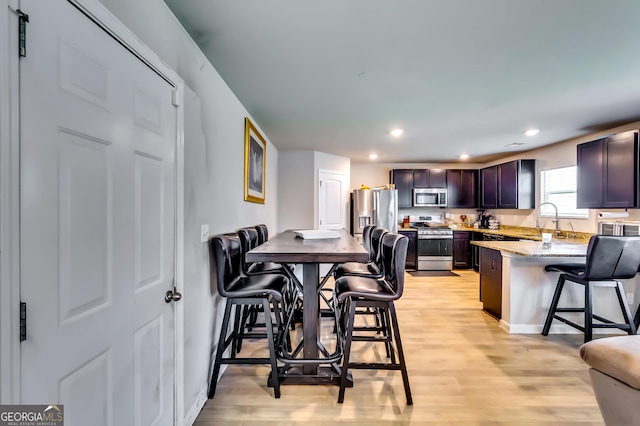 dining space featuring recessed lighting, light wood-style floors, and baseboards